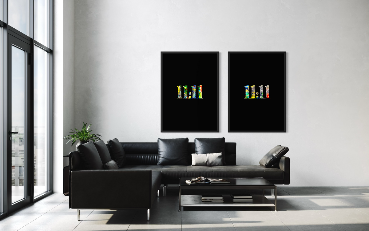 A modern living room with a black sectional sofa and coffee table, featuring two vertical black art prints with colorful abstract lettering hanging on the wall above the sofa.