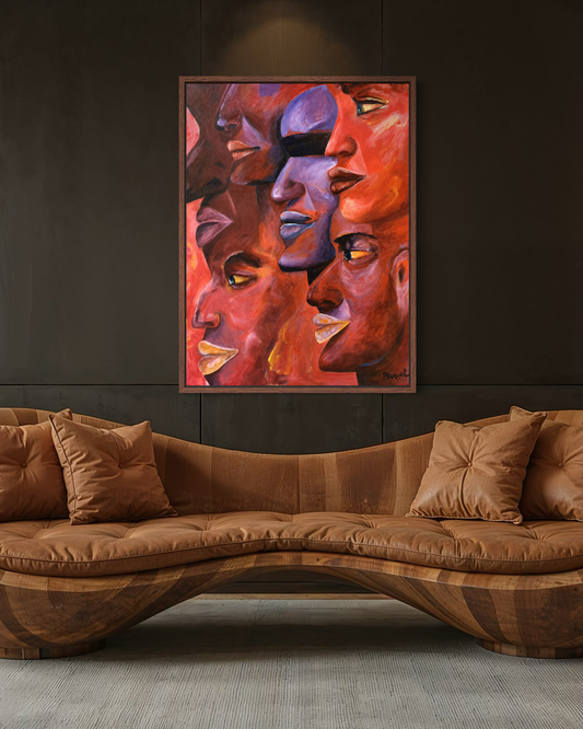 A framed abstract painting of multiple stylized faces in warm red, orange, purple, and brown tones, displayed on a dark wall above a curved brown sofa.