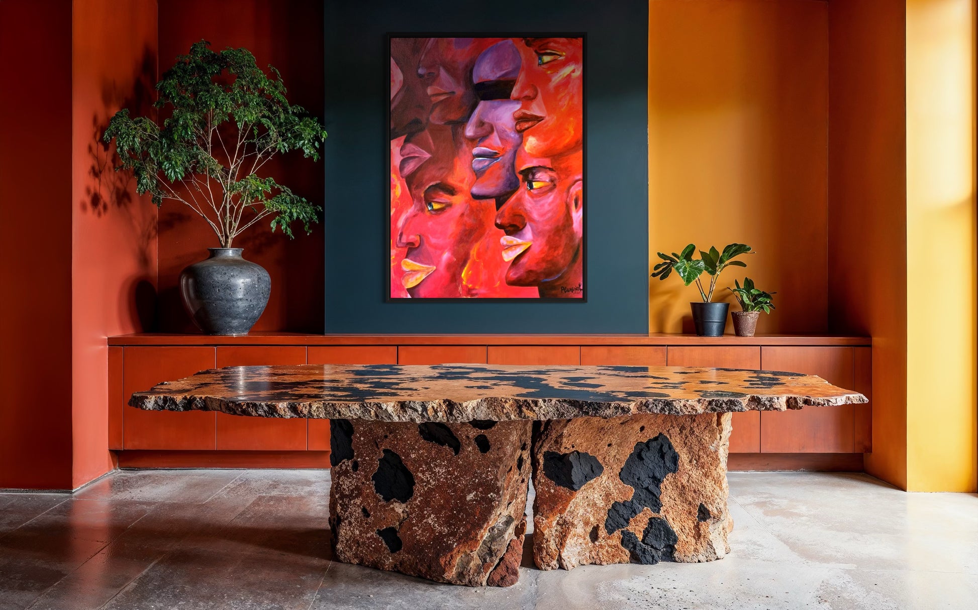 Decorative stone table in a room with a colorful abstract painting on the wall.