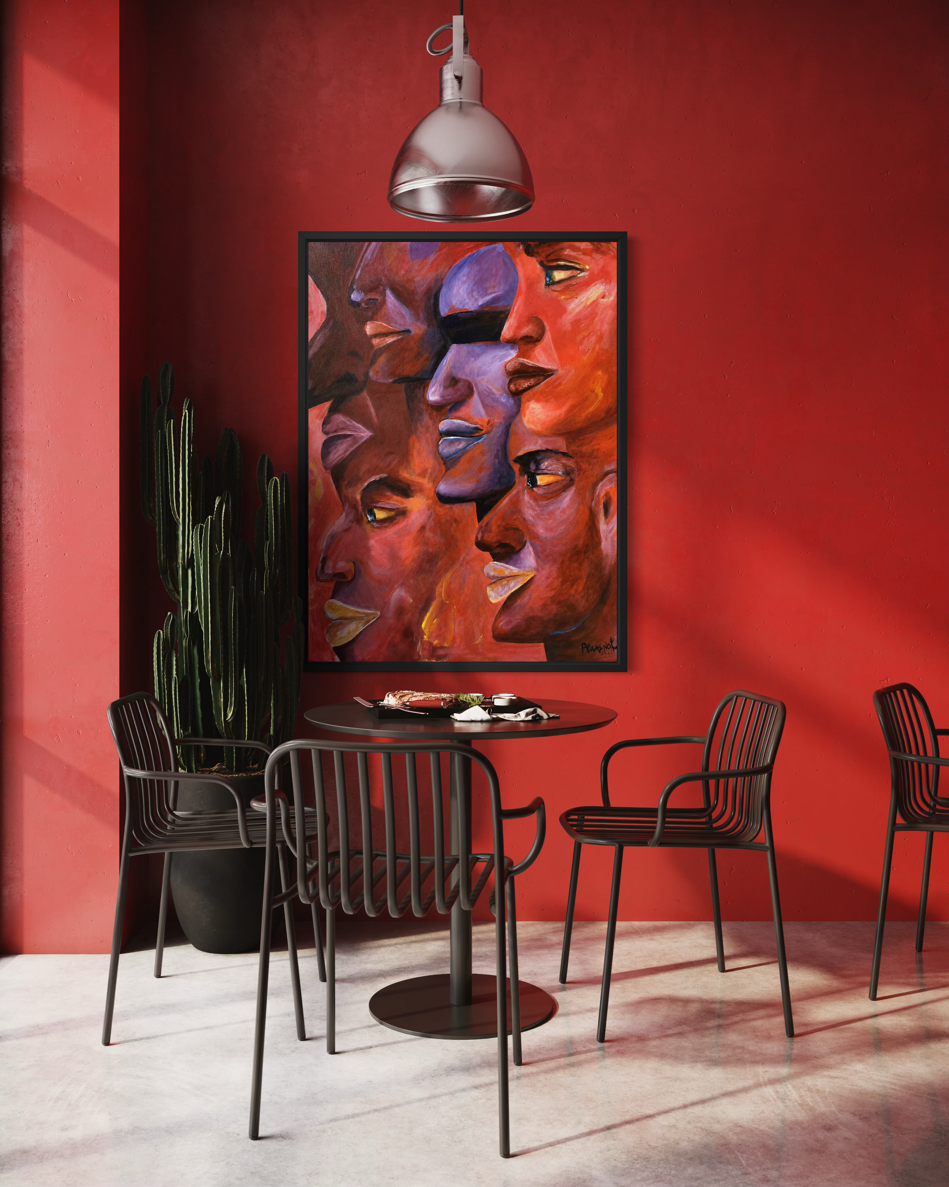 A large framed abstract art print depicting stylized faces in warm red, orange, and purple tones, hung on a vibrant red wall in a modern dining room setting with black chairs and a small table.
