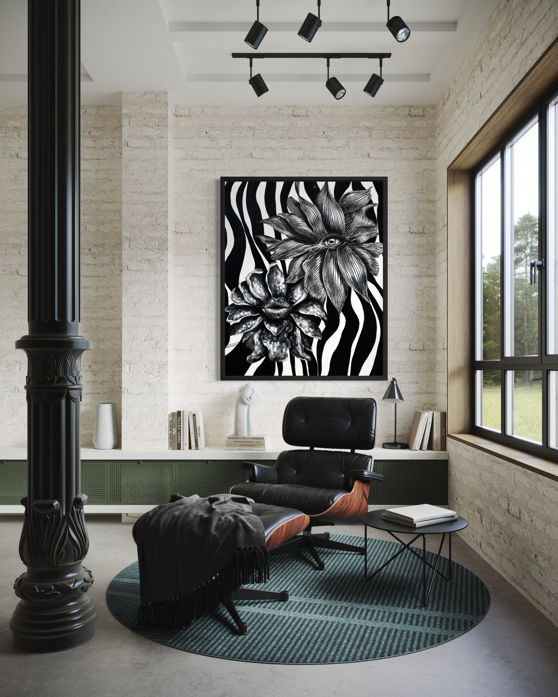 A black and white floral zebra-print framed wall art piece hangs in a modern living room setting above an Eames-style lounge chair and ottoman on a round teal rug.