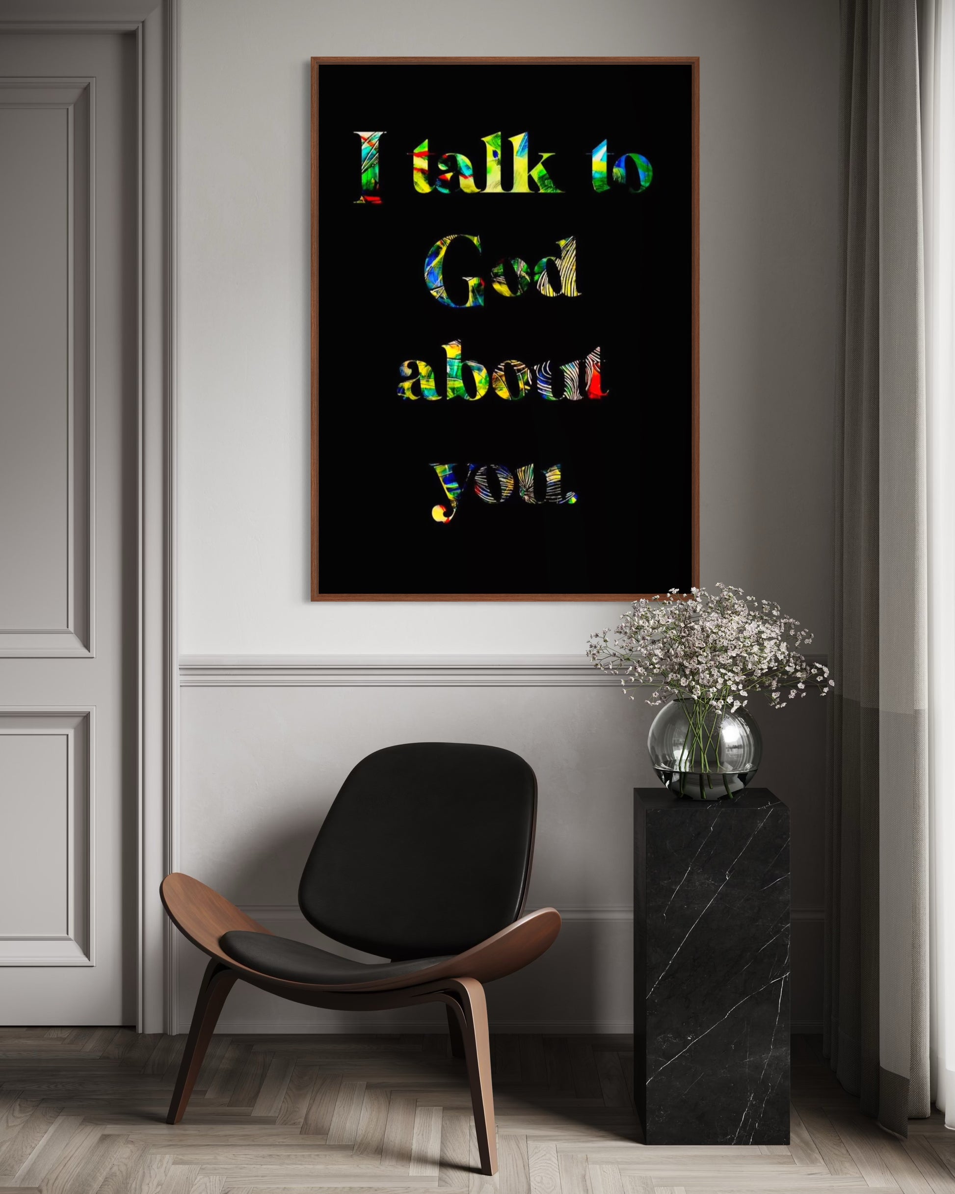 Framed artwork with colorful text on a wall above a modern chair and side table.